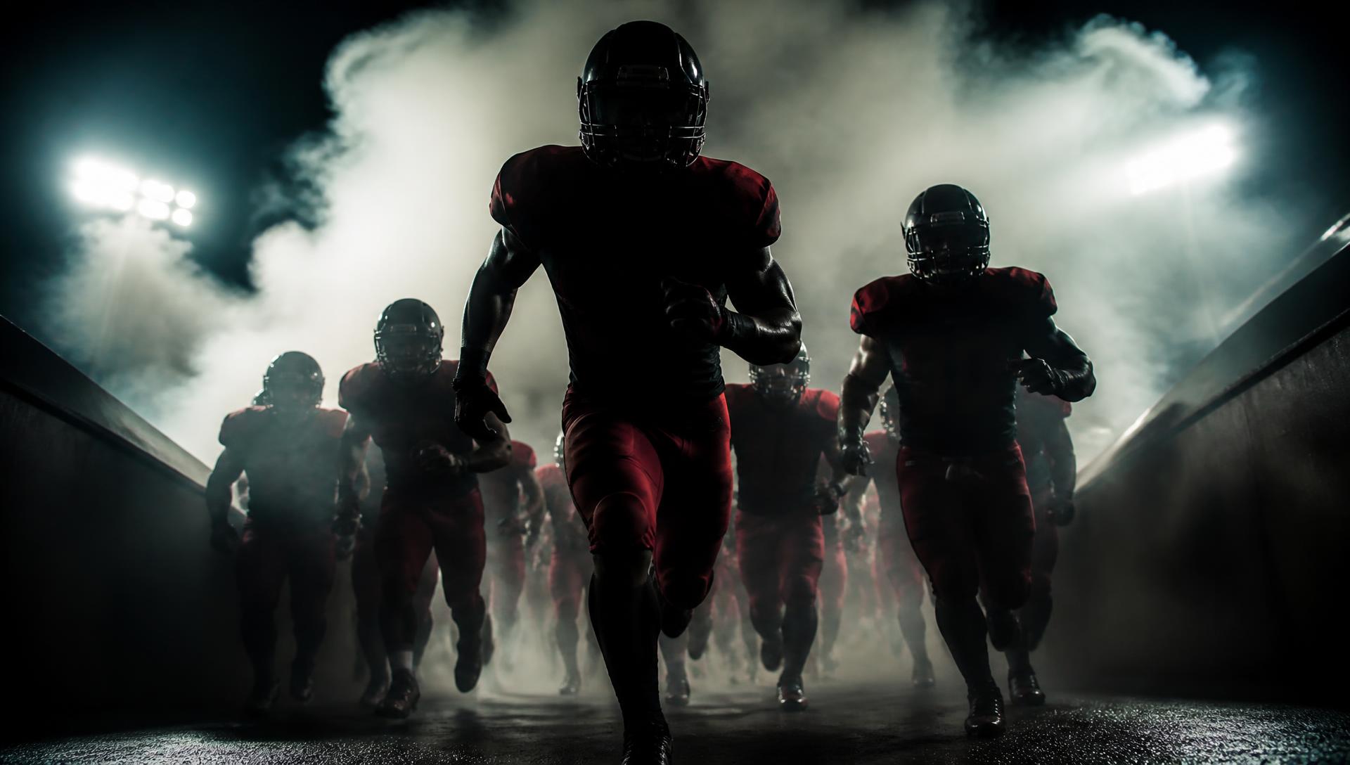 Stallions players running out of the stadium tunnel through smoke